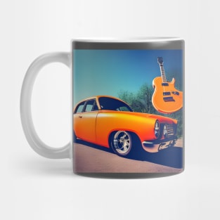 An Orange Guitar Suspended above An Orange Car Mug